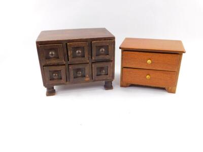 An oak spice chest of six drawers, raised on turned feet, 60.5cm high, 20cm wide, 14cm deep., together with a teak and plywood apprentice chest of two long drawers, raised on bracket feet, 13cm high, 17cm wide, 11cm deep. (2)