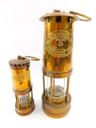 An E Thomas & Williams Ltd Cambrian miner's lamp, No 60199, 25cm high, together with a smaller lamp, 16cm high. (2)