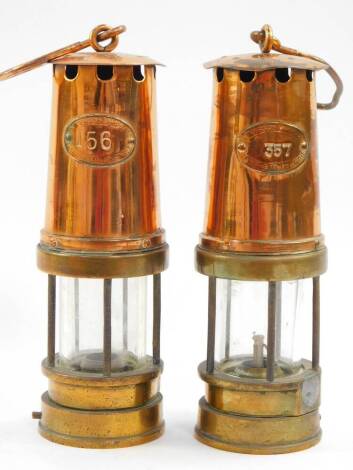 A pair of Patterson Lamps Ltd copper and brass miner's safety lamps, Nos 156 and 357.