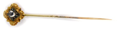 A Victorian stick pin set with an old cut diamond, in white and yellow metal, approx 0.4cts.