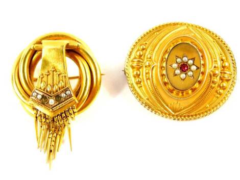 A Victorian Etruscan Revival brooch, set with seed pearls in yellow metal, two pearls lacking, 6.9g., together with a Victorian foiled metal brooch, set with a garnet in a surround of seed pearls, stamped 9ct, 3.5g. (2)