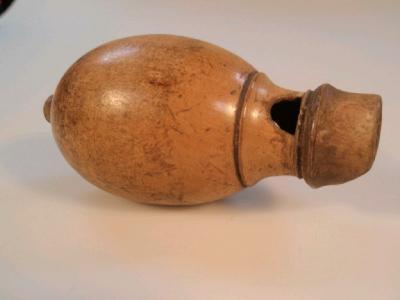 An antique turned boxwood pigeon call