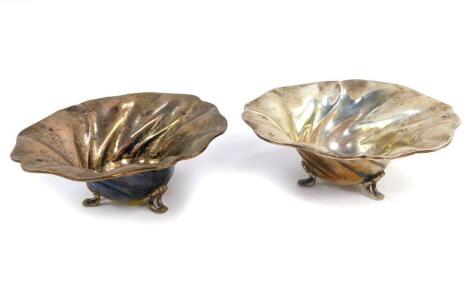 A pair of sterling silver sweetmeat dishes, of spiral fluted form, raised on three leaf cast feet, 13.5cm diameter, 7.57oz.