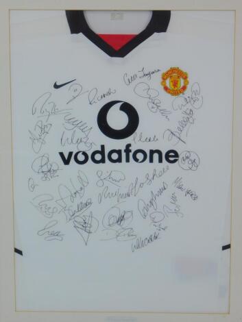 A Manchester Utd Vodafone white football shirt, bearing various signatures c2002/2003, framed and glazed.