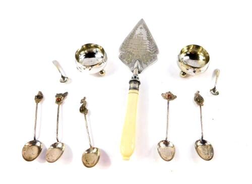 A pair of silver plated circular salts, raised on ball feet, with spoons, five Far Eastern gem set coffee spoons, with various terminals, and an Edwardian silver plate and ivory handled trowel, presentation engraved 'New Wesleyan Chapel Longwood, Memorial