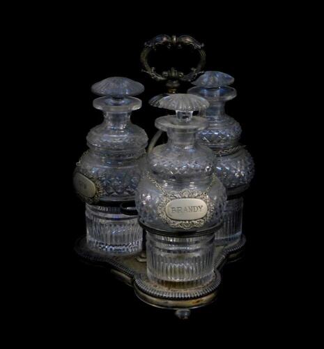 A Victorian silver plated three bottle cruet, containing three cut glass decanters and stoppers, with plated decanter labels, 28cm high.