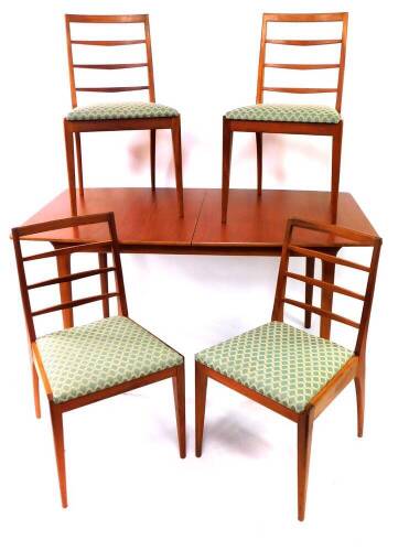 A 1970's teak extending dining table, with folding centre section, and four ladder back chairs with drop - in seats, stamped 1973, table 83cm wide, 150cm long when closed.