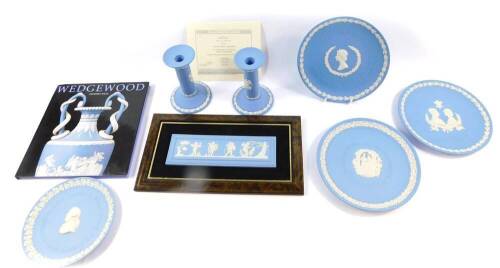 A group of Wedgwood light blue Jasperware, mostly boxed, including a pair of Dancing Hours candlesticks, a plaque, plates, and a book on Wedgwood by Geoffrey Wills. (a quantity)