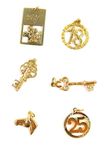 Six 9ct gold charms, including two keys, a horse's head and a St Christopher, 9.6g.