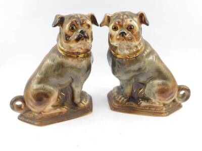 A pair of Scottish Bo'ness pottery pug dogs, c1900, modelled in seated pose with glass eyes, 31cm high. (one eye lacking)