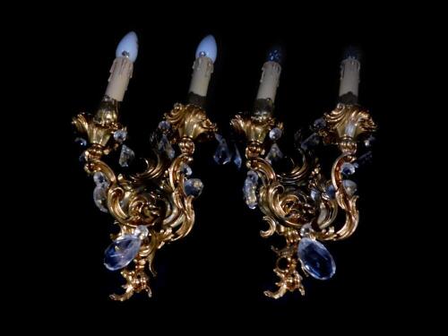 A pair of Italian brass baroque style twin branch wall lights, with cut glass drops, 43cm high.