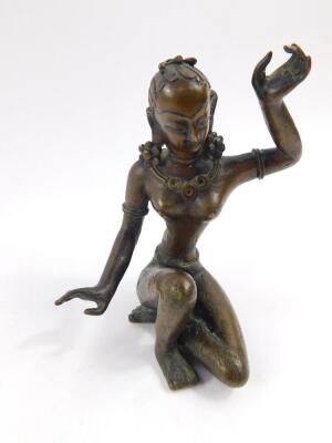 An early 20thC bronze figure of a Buddhist goddess, modelled semi naked and seated, 12cm high.