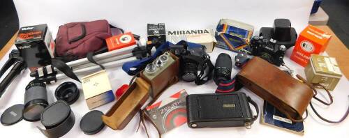 A Eumig Cine camera, model C3., Kodak camera, Zenit 11 camera, tripods, accessories and books. (a quantity)