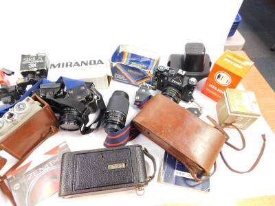 A Eumig Cine camera, model C3., Kodak camera, Zenit 11 camera, tripods, accessories and books. (a quantity) - 3