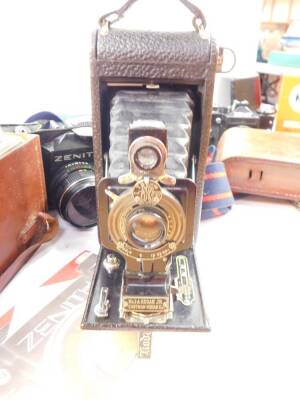 A Eumig Cine camera, model C3., Kodak camera, Zenit 11 camera, tripods, accessories and books. (a quantity) - 5