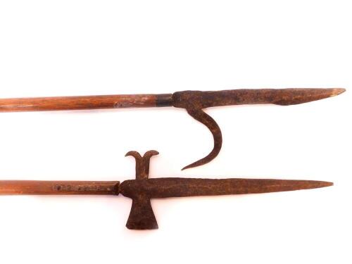 Two forged iron and wooden handled reenactment pikes, 235cm high and 233cm high respectively.