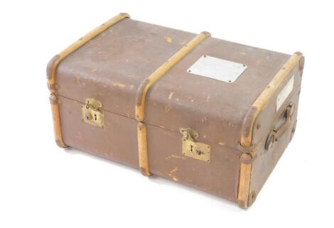 A canvas and wooden bound trunk, with railway labels and named for a pupil at the Old House School, Bembridge, Isle of Wight, 34cm high, 69cm wide, 48cm deep.