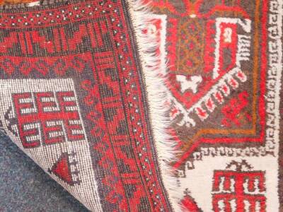 A Caucasian red ground prayer rug, decorated with six central geometric motifs and lanterns, within repeating geometric borders, 166cm x 89cm. - 3