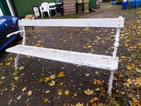 A Coalbrookdale style white painted garden bench, with rustic branch ends, 182cm wide, 58cm deep.