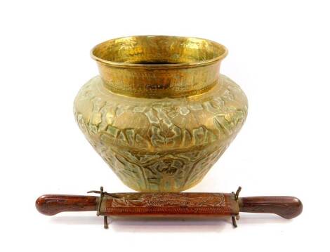 A 19thC Indian brass jardiniere, embossed with animals, figures, and birds, 34cm diameter, together with a hard wood knife and fork set. (2)