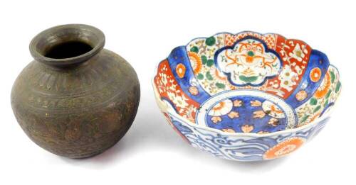 A 19thC Japanese imari bowl, 22cm diameter, (AF), and an antique Indian brass and copper globular vase, 16cm diameter. (2)