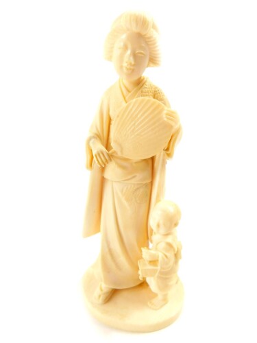 A Japanese Tokyo School ivory okimono, of a geisha with fan, child and toy, signed Kosshi (?), to the base,Taisho period, 16.5cm high.