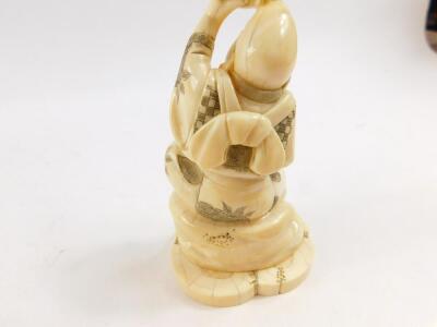 A Japanese marine ivory okimono of Ebisu, holding his carp above his head in one hand, his double gourd sake bottle and bowl in the other hand, signed Unichi (?) to base Meiji period, 13.5cm High. - 4