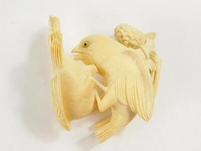 A Japanese ivory okimono, of a pair of sparrows squabbling over a head of millet, Meiji period, 11cm diameter, (AF). - 2