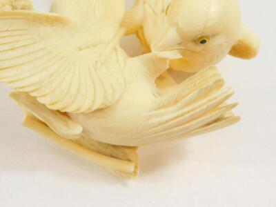 A Japanese ivory okimono, of a pair of sparrows squabbling over a head of millet, Meiji period, 11cm diameter, (AF). - 3