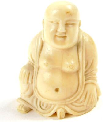 An Oriental ivory figure of a seated Buddha, (being part of another composition with insert to side of head), 19thC., 5cm high.