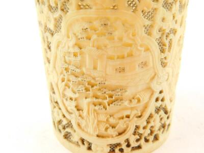 A 19thC Chinese Canton decorated and pierced brush pot, with shaped panels of a riverside scene 9.5cm high, 8cm diameter, and a similar Chinese Canton deeply carved oval plaque, 4.5cm wide. (2) - 5