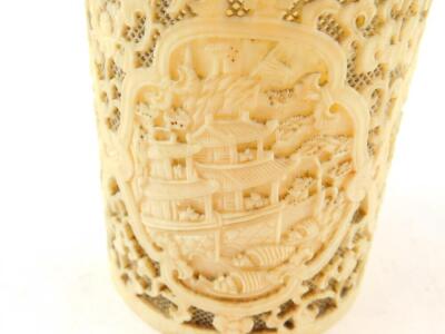 A 19thC Chinese Canton decorated and pierced brush pot, with shaped panels of a riverside scene 9.5cm high, 8cm diameter, and a similar Chinese Canton deeply carved oval plaque, 4.5cm wide. (2) - 6