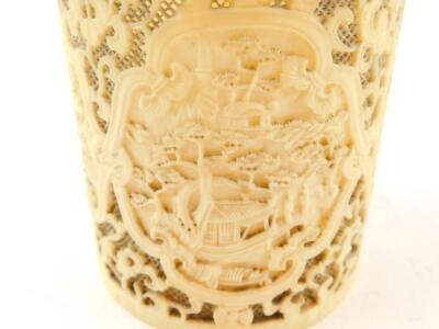 A 19thC Chinese Canton decorated and pierced brush pot, with shaped panels of a riverside scene 9.5cm high, 8cm diameter, and a similar Chinese Canton deeply carved oval plaque, 4.5cm wide. (2) - 7