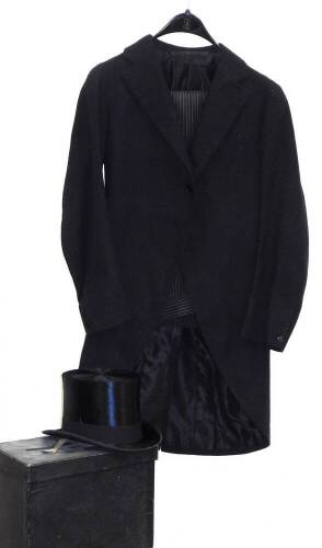 A Cope Brothers top hat in black, with interior label and case, 14cm high, interior measurements approx 21cm x 16cm, together with an overcoat and striped trousers.