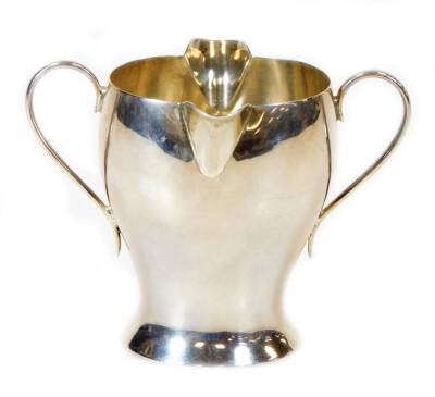 A Victorian silver double lipped Art Nouveau cream jug, by Samuel Walton Smith, with inverted body and plain handles, London 1897, 8cm high, 3oz.