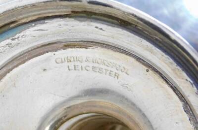 A George V silver trophy, of circular form with ear handles, on a turned stem and circular foot, marked Grantham and District Agricultural Association 1922 won by Mr Matthew Hubbard of Eaton, Birmingham 1921, 12cm high, on an ebonised plinth base, 6.8oz o - 4