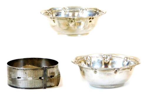 A belt shaped bangle, marked sterling silver, when fastened, 8cm diameter, and two florally shaped bowls. (3)