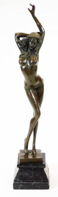 An Art Deco style bronze finish figure of a nude lady, in standing pose with left arm outstretched, on a stepped and inverted marble finish base, indistinctly signed to the back, 58cm high,