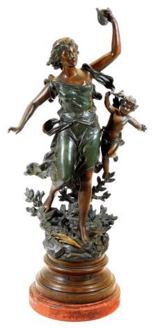 A late 19thC Poesie Lyrique cast metal figure of a lady scantily dressed, aside cherub, on a naturalistic base, with red marble finish, titled plinth, 65cm high.