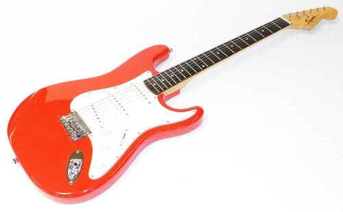 A Squier Fender Bullet six string electric guitar, in red and white colourway, 101cm wide, in associated canvas case.