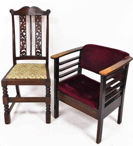 A 1920's oak occasional chair, with overstuffed back and seat, in crimson material, on chamfered stiles, 68cm high, and a comb top oak framed chair with shaped vertical pierced floral double back splat, on turned front legs with drop in seat, in later flo