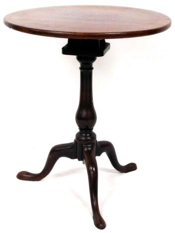 A George III mahogany one piece birdcage action tripod table, on plain baluster stem terminating in triple cabriole legs, 68cm high, the top 60cm diameter.