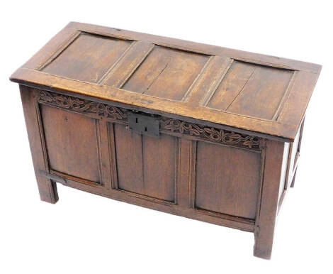 A 17thC oak three panelled coffer, of rectangular form with iron lock, plain front panels on block stiles with candle box to the interior, joints original and tight. 60cm high, 98cm wide, 49cm deep.