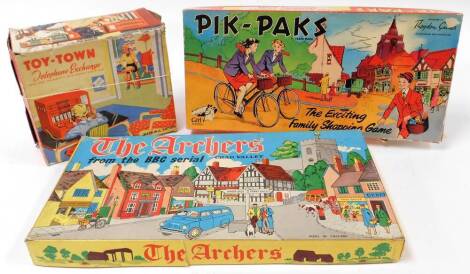 Various vintage games, a boxed Toy Town telephone exchange marked made in Great Britain game, the box 24cm wide, Pik-paks and The Archers. (3)