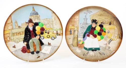 A pair of Royal Doulton wall plates, The Old Balloon Seller and The Balloon Man, D6655, printed marks beneath, 26cm diameter. (2)