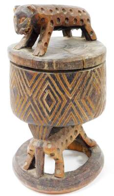 An African tribal headrest sculpture, with wild cat top, heavily carved cylindrical stem, resting on an animal's back, on a circular base, 46cm high. - 2