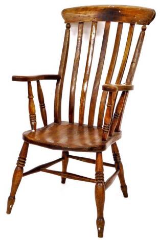 A 19thC ash and elm lath back chair, with cone topped cresting rail, vertical splat, shaped seat and arms and ring turned legs, joined by a H stretcher, 110cm high.