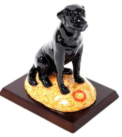 A Royal Doulton boxed figure of a black Labrador, RDA13 printed marks beneath, 14cm high. (boxed)