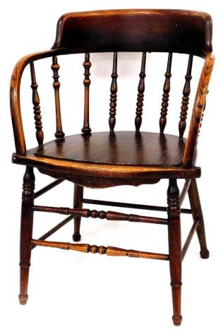 A 1920's oak bentwood Thonet style armchair, with shaped cresting rail on turned supports, on ring turned front legs joined by a double horizontal front stretcher, 81cm high.