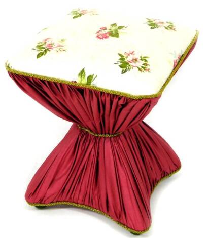 An early 20thC Diabolo stool of hourglass form, all over upholstered in floral material, 50cm high, 40cm wide, 40cm deep.